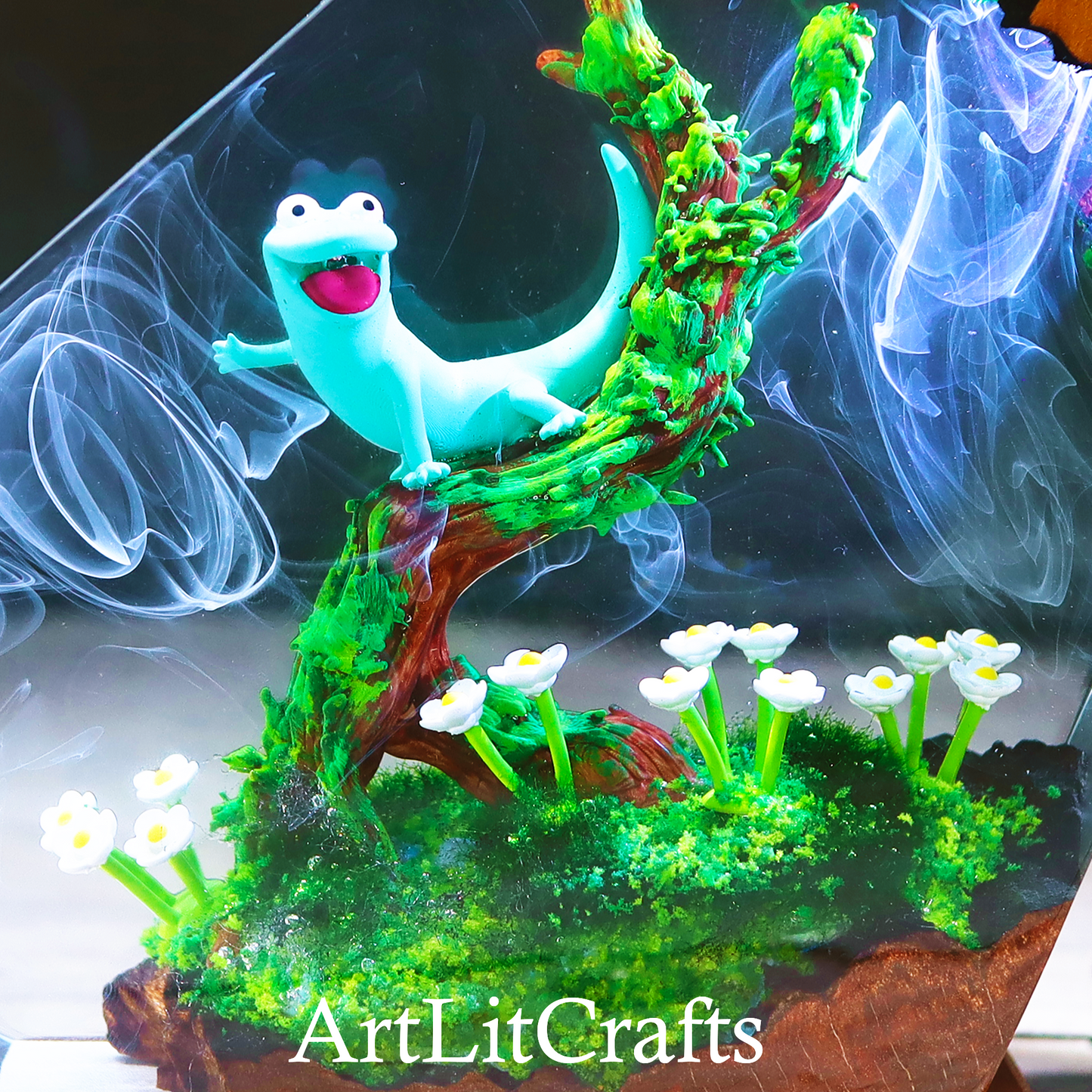 Animated smiling Gecko on a branch with flowers, featuring 'ArtLitCrafts' branding.