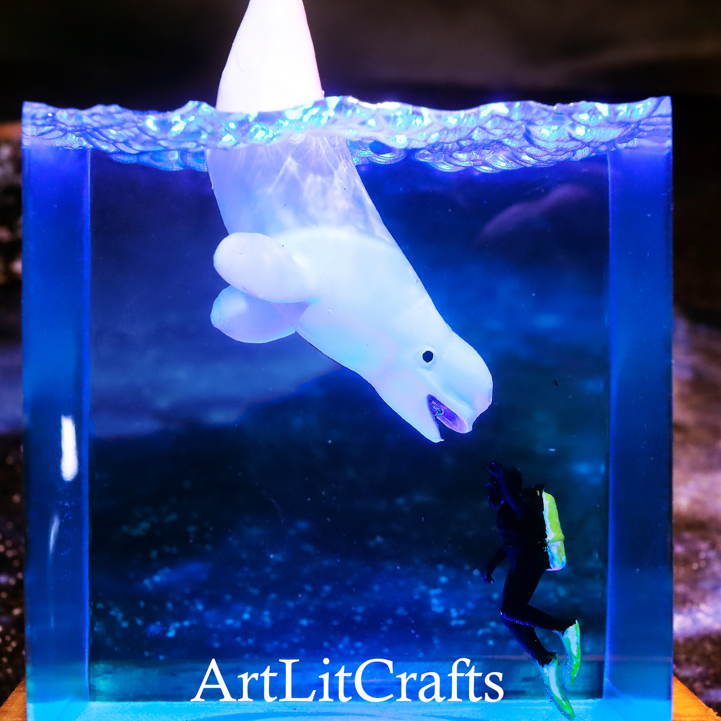 close up detail of handmade beluga whale resin lamp, branded 'ArtLitCrafts'.