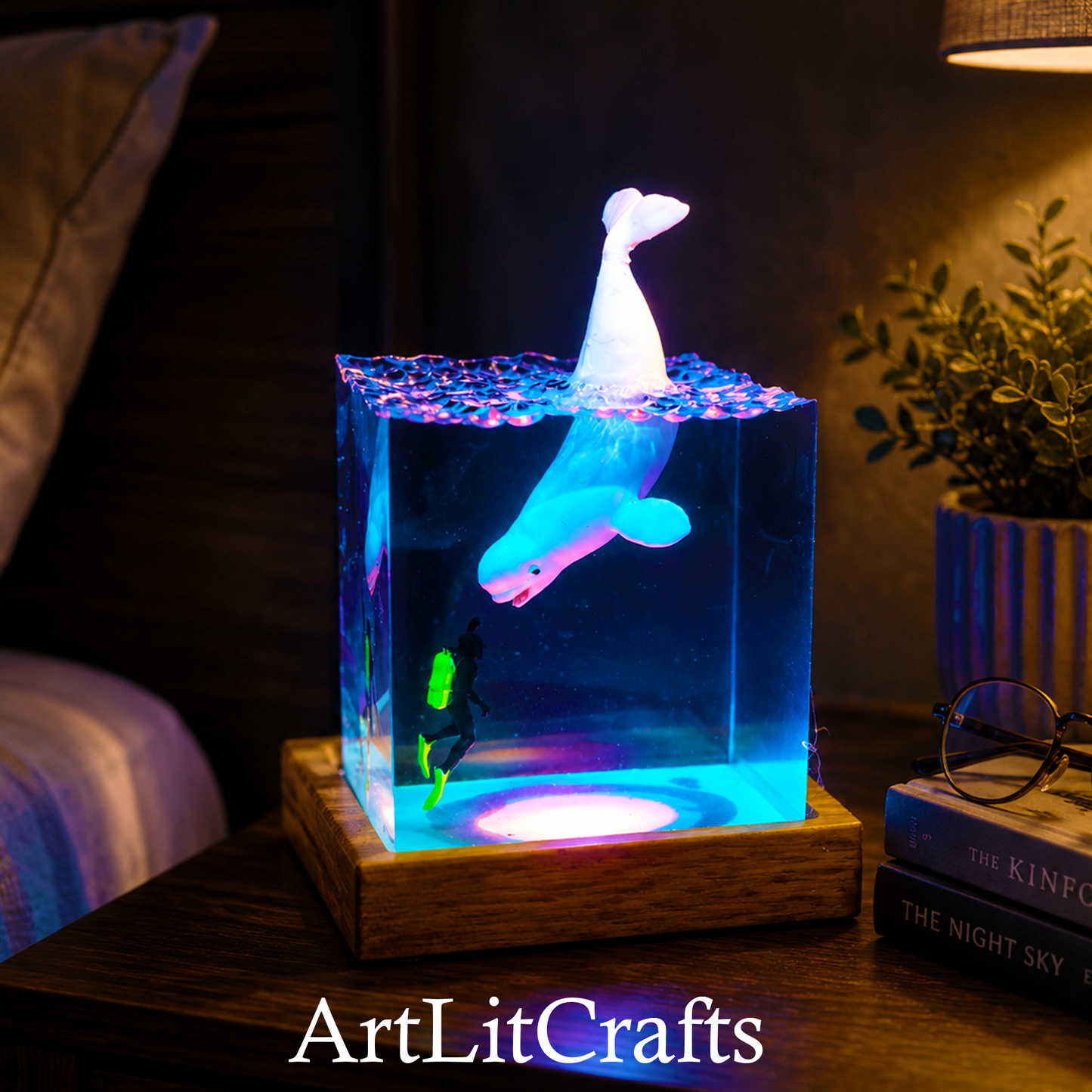 beluga whale resin lamp used as bedside night light, illuminated with purple lighting, branded 'ArtLitCrafts'.