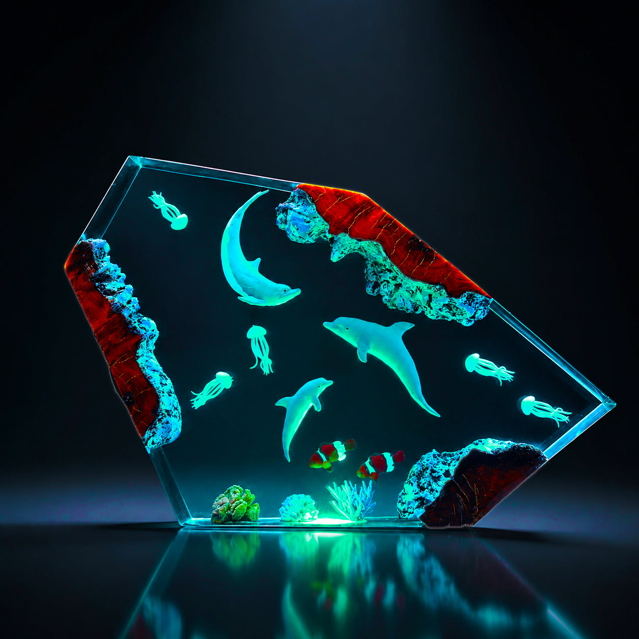 Ocean epoxy resin lamp featuring three dolphins swimming through deep sea waters