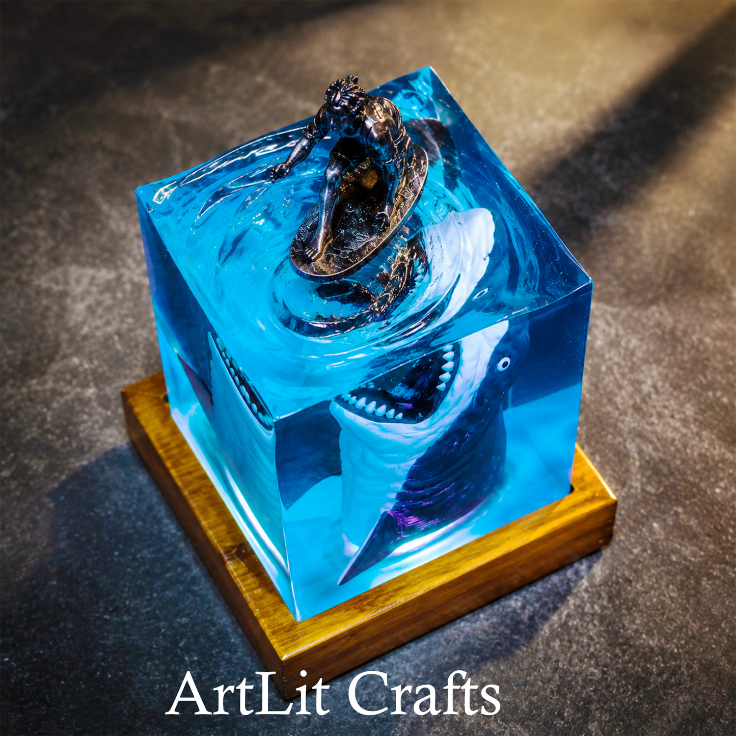 Blue resin sculpture of a shark on a wooden base with 'ArtLit Crafts' branding.