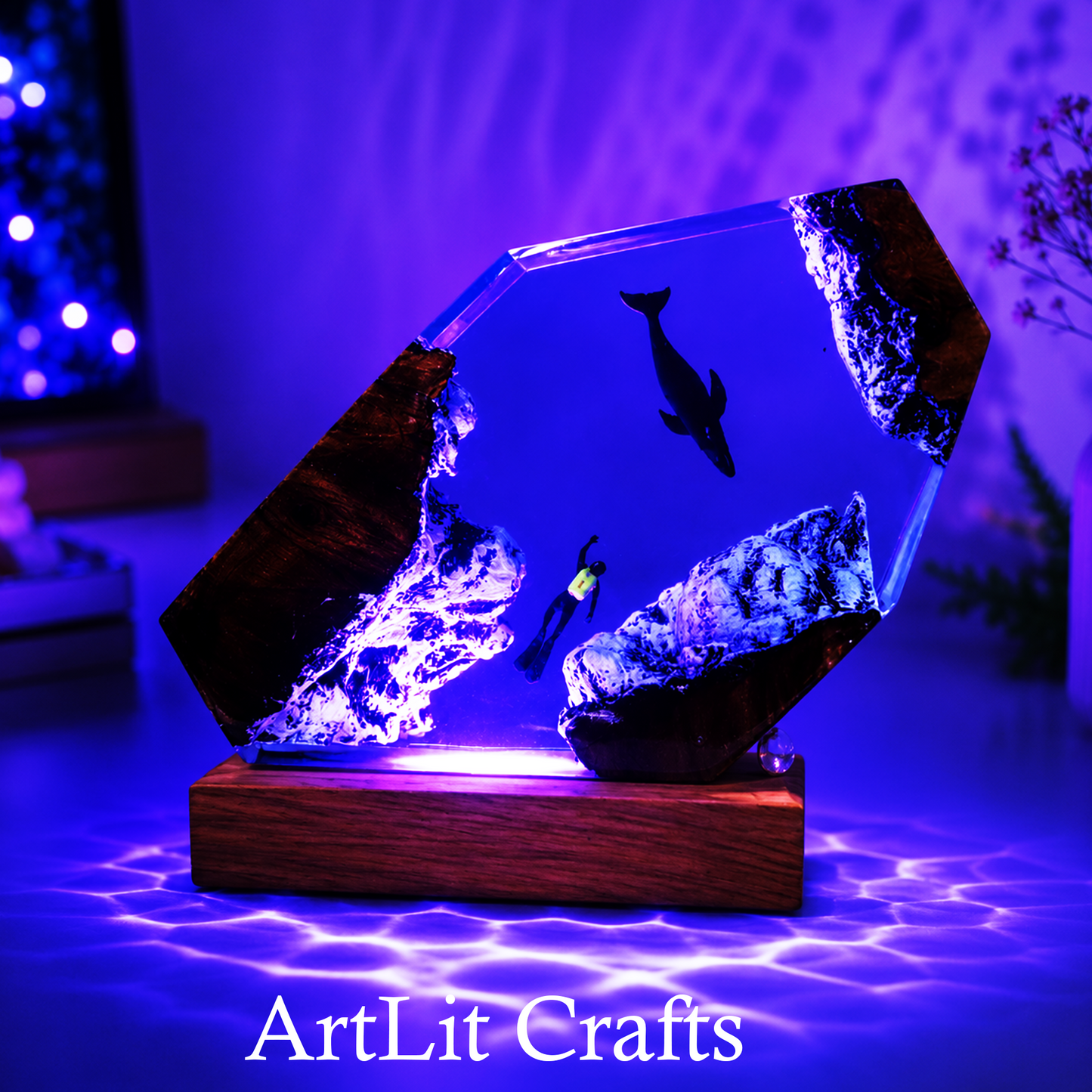 Glass sculpture with underwater scene on a wooden base, illuminated with purple light, branded 'ArtLit Crafts'.