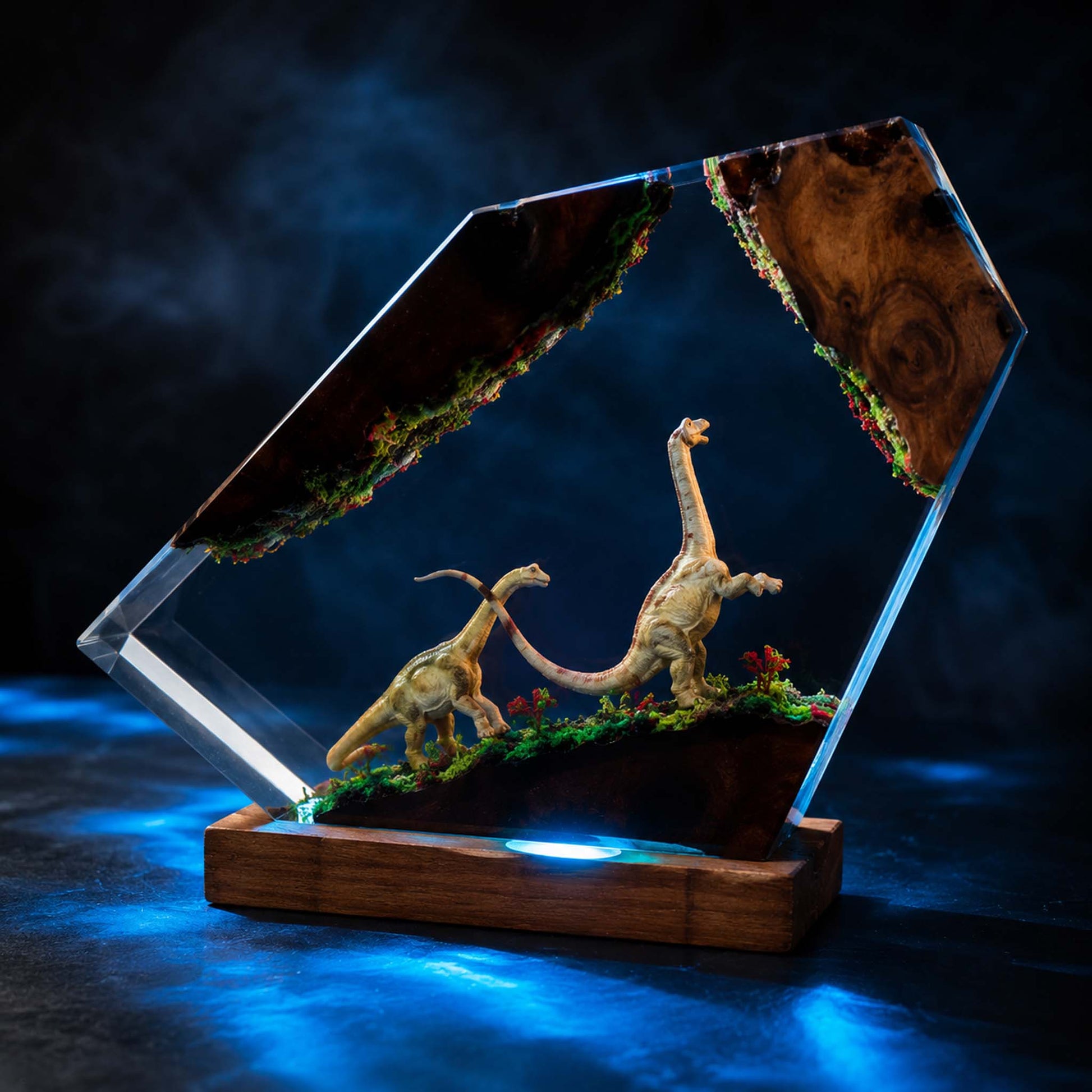 Dinosaur model inside epoxy resin lamp, display case on a dark background
